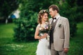 Young happy bride and groom on the background of greenery Royalty Free Stock Photo