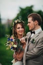 Young happy bride and groom on the background of greenery Royalty Free Stock Photo