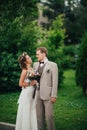 Young happy bride and groom on the background of greenery Royalty Free Stock Photo