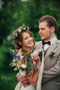 Young happy bride and groom on the background of greenery Royalty Free Stock Photo