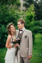 Young happy bride and groom on the background of greenery Royalty Free Stock Photo