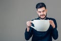 Business man holding a funny huge and oversized cup of black coffee in caffeine Royalty Free Stock Photo