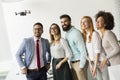 Young happy business people letting the drone camera to fly over the office and having fun