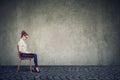 Young happy business woman sitting on a chair using her laptop computer Royalty Free Stock Photo