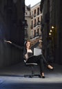 Young Happy Business woman sitting on Office Chair on Street with Laptop Royalty Free Stock Photo