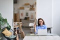 Young happy business woman or student working on laptop pointing aside. Royalty Free Stock Photo