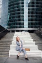 Young happy business woman talking on the phone in the background of an office building Royalty Free Stock Photo