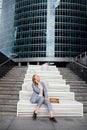 Young happy business woman talking on the phone in the background of an office building Royalty Free Stock Photo