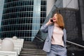 Business woman talking on the phone in the background of an office building Royalty Free Stock Photo