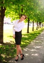 Young and happy business woman walking in city green park Royalty Free Stock Photo