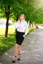 Young and happy business woman walking in city green park Royalty Free Stock Photo