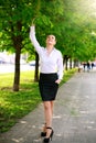 Young and happy business woman walking in city green park Royalty Free Stock Photo