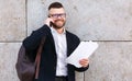 Young happy businessman in formal clothes speaking on mobile phone with client or partner outside Royalty Free Stock Photo