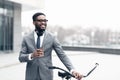 Young happy businessman going to work by bike Royalty Free Stock Photo