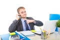 Young happy businessman smiling confident talking on mobile phone at office computer desk Royalty Free Stock Photo