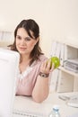 Young happy businesswoman holding apple at office Royalty Free Stock Photo