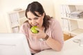 Young happy businesswoman holding apple at office Royalty Free Stock Photo