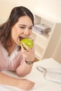 Young happy businesswoman holding apple at office Royalty Free Stock Photo