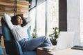 Young happy businesswoman relaxing at office lobby, Smiling woman working on laptop computer in modern office, successful business Royalty Free Stock Photo