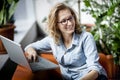 Young happy businesswoman using laptop in office. Royalty Free Stock Photo