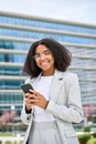 Young happy busy African American business woman using phone in city. Royalty Free Stock Photo