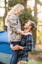 Young happy camper holding his smiling girlfriend Royalty Free Stock Photo