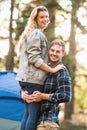 Young happy camper holding his smiling girlfriend Royalty Free Stock Photo