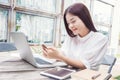 Young happy casual asian woman using technology on her laptop co Royalty Free Stock Photo