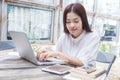 Young happy casual asian woman using technology on her laptop co Royalty Free Stock Photo