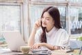 Young happy casual asian woman using technology on her laptop co Royalty Free Stock Photo
