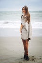 Young happy casual woman hikiing on a sea beach, autumn outdoor