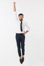 Young happy caucasian businessman jumping in the air , isolated on white background. Royalty Free Stock Photo