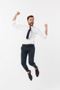 Young happy caucasian businessman jumping in the air , isolated on white background. Royalty Free Stock Photo