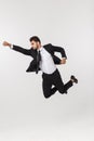 Young happy caucasian businessman jumping and flying in the air , isolated on white background Royalty Free Stock Photo