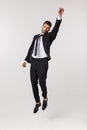 Young happy caucasian businessman jumping and flying in the air , isolated on white background Royalty Free Stock Photo