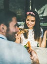 Young happy caucasian couple eating pizza in cafe Royalty Free Stock Photo