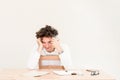 Young, happy Caucasian freelancer man sitting in his home office at the table in front of empty clear wall. Royalty Free Stock Photo