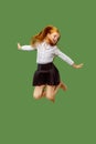 Young happy caucasian teen girl jumping in the air , isolated on green background Royalty Free Stock Photo