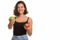 Young happy Caucasian teenage girl smiling holding red apple and Royalty Free Stock Photo