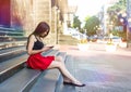 Young happy caucasian woman texting sms in city outdoor. Relax lifestyle summer concept Royalty Free Stock Photo