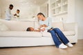 Young happy and cheerful african american mother playing and bonding with her daughter on the couch in the lounge at Royalty Free Stock Photo