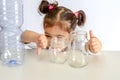 Plastic free, save planet concept. Child showing thumb up for glass jar, thumbs down for plastic bottle