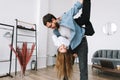 Young happy cheerful couple having fun in living room at home Royalty Free Stock Photo