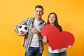 Young happy cheerful couple supporter, woman man, football fans cheer up support team, holding red heart love, soccer Royalty Free Stock Photo