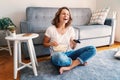 Young happy cheerful fuuny woman watchingTV, movies and eating popcorn, spending time at home