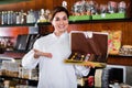 Female seller offering large box of chocolates Royalty Free Stock Photo