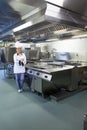 Young happy chef standing next to work surface Royalty Free Stock Photo