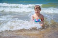 Girl of having fun in water on the beach and splashing