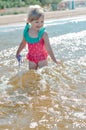 Girl of European appearance having fun in water on the beach