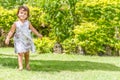 Young happy child girl running on outdoor natural back
